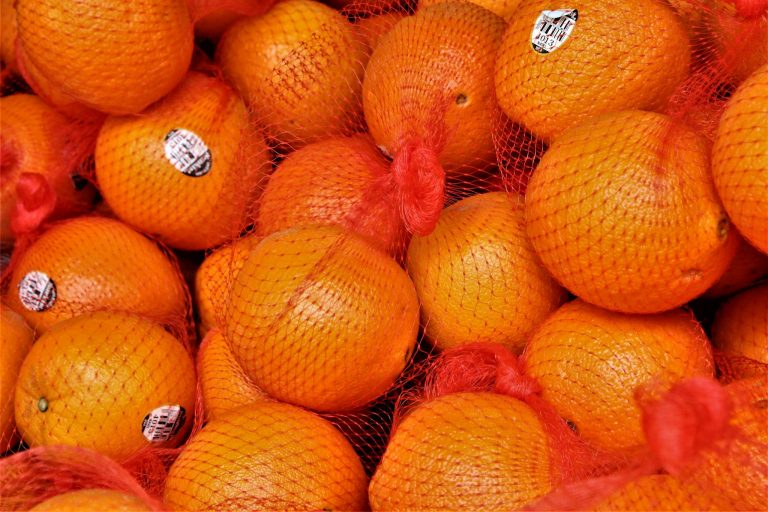 Fresh bright mandarins with stickers in bag